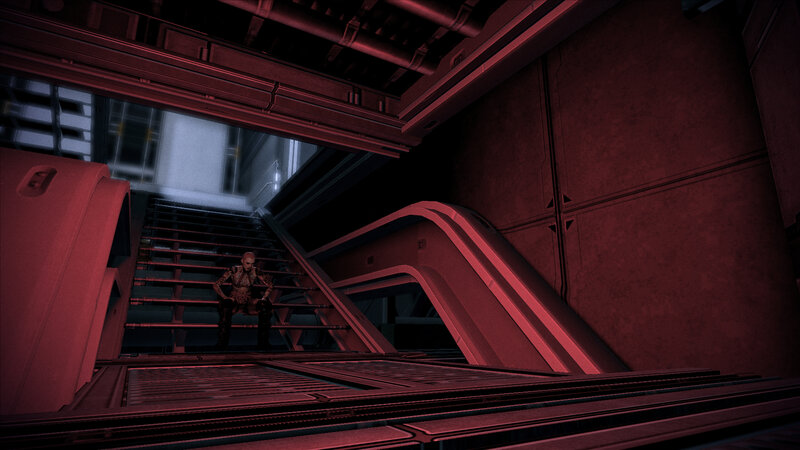 Character on stairs in red-lit corridor