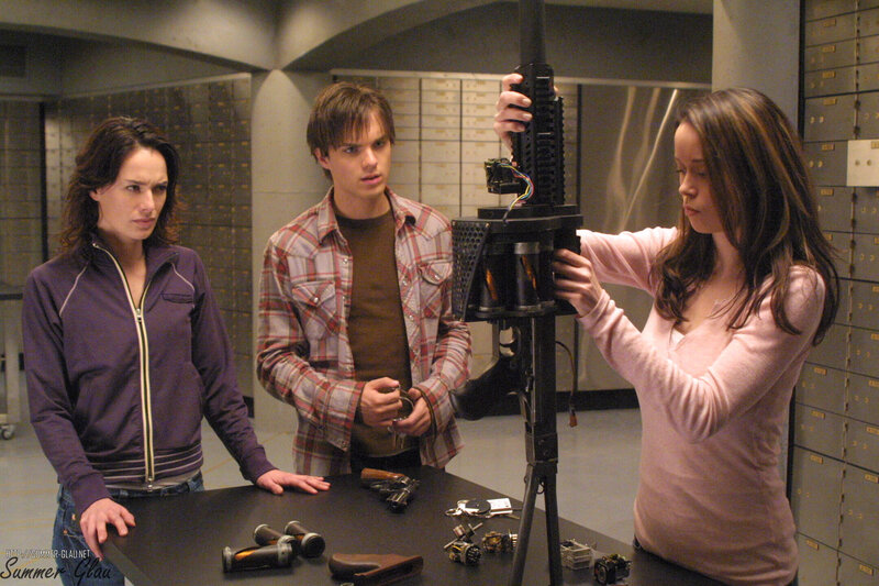 Characters examining a weapon