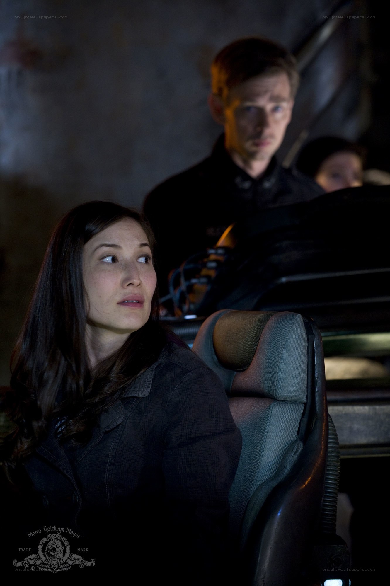 Characters in a dimly lit vehicle