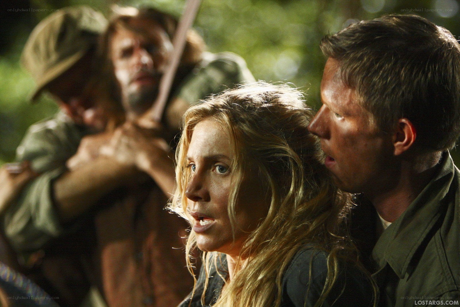 Characters in a tense forest scene