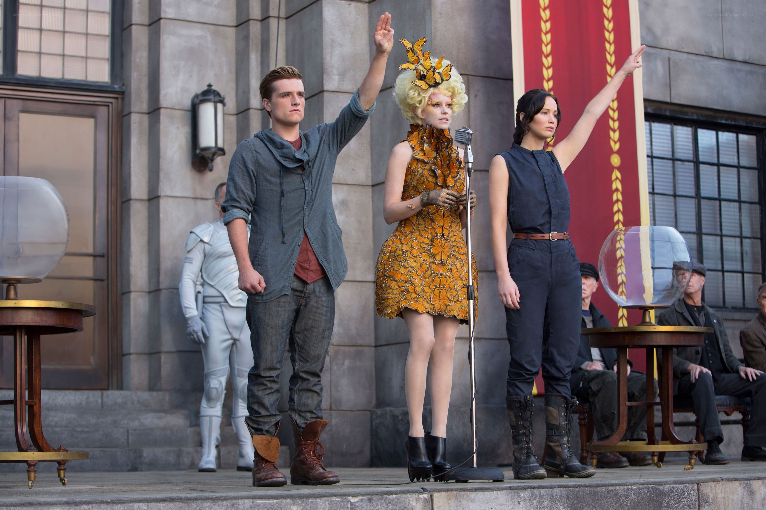 Characters on a stage with raised hands