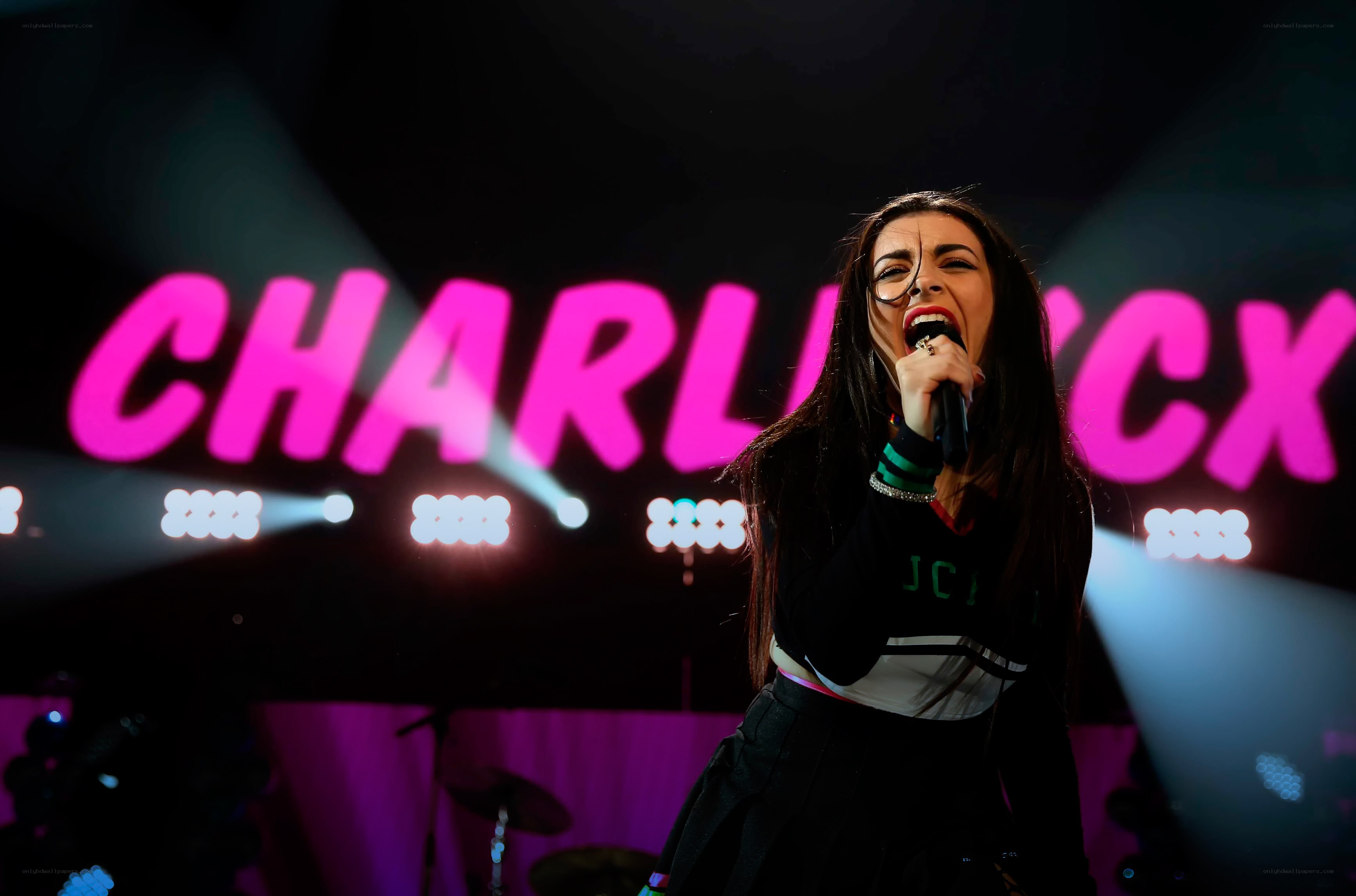 Charli XCX performing on stage