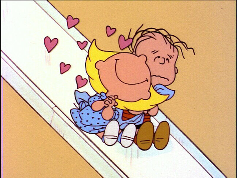 Charlie Brown hugging a girl