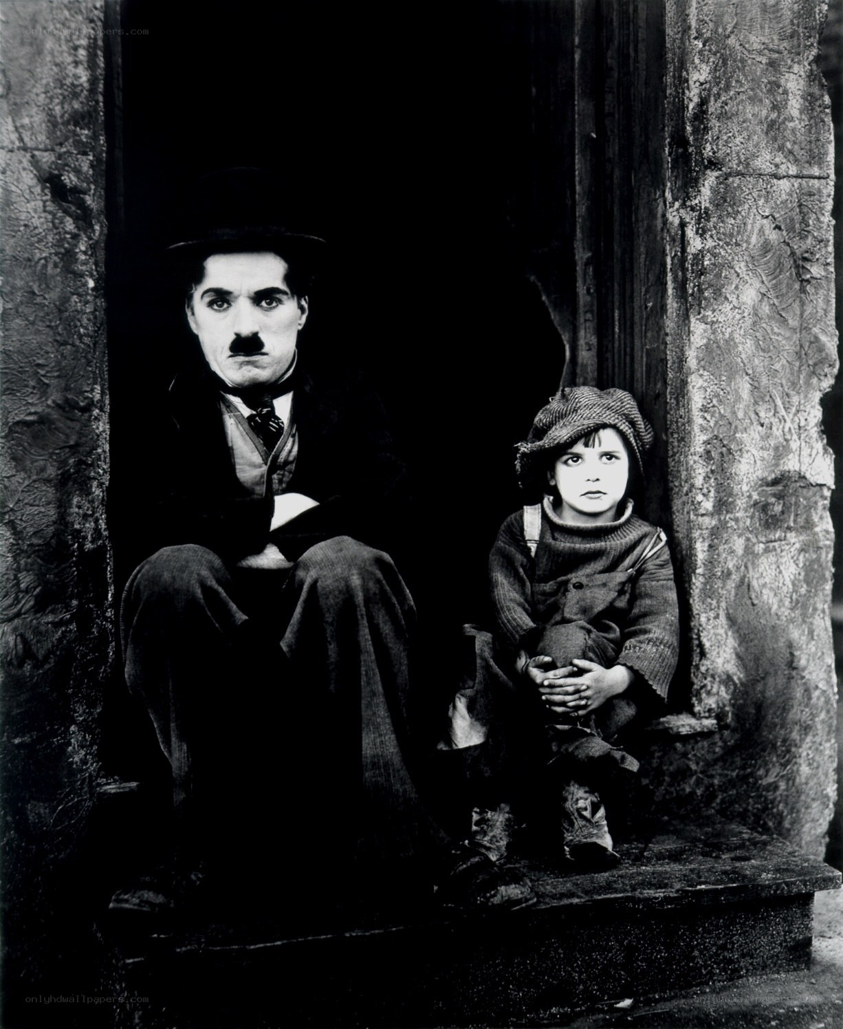 Charlie Chaplin and child on steps