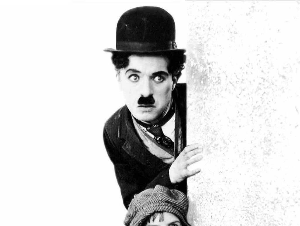 Charlie Chaplin peeking from wall