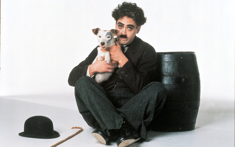 Charlie Chaplin with dog and barrel