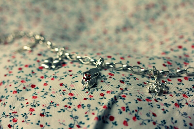 charm bracelet on floral fabric