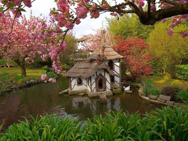 Charming pond house in spring garden