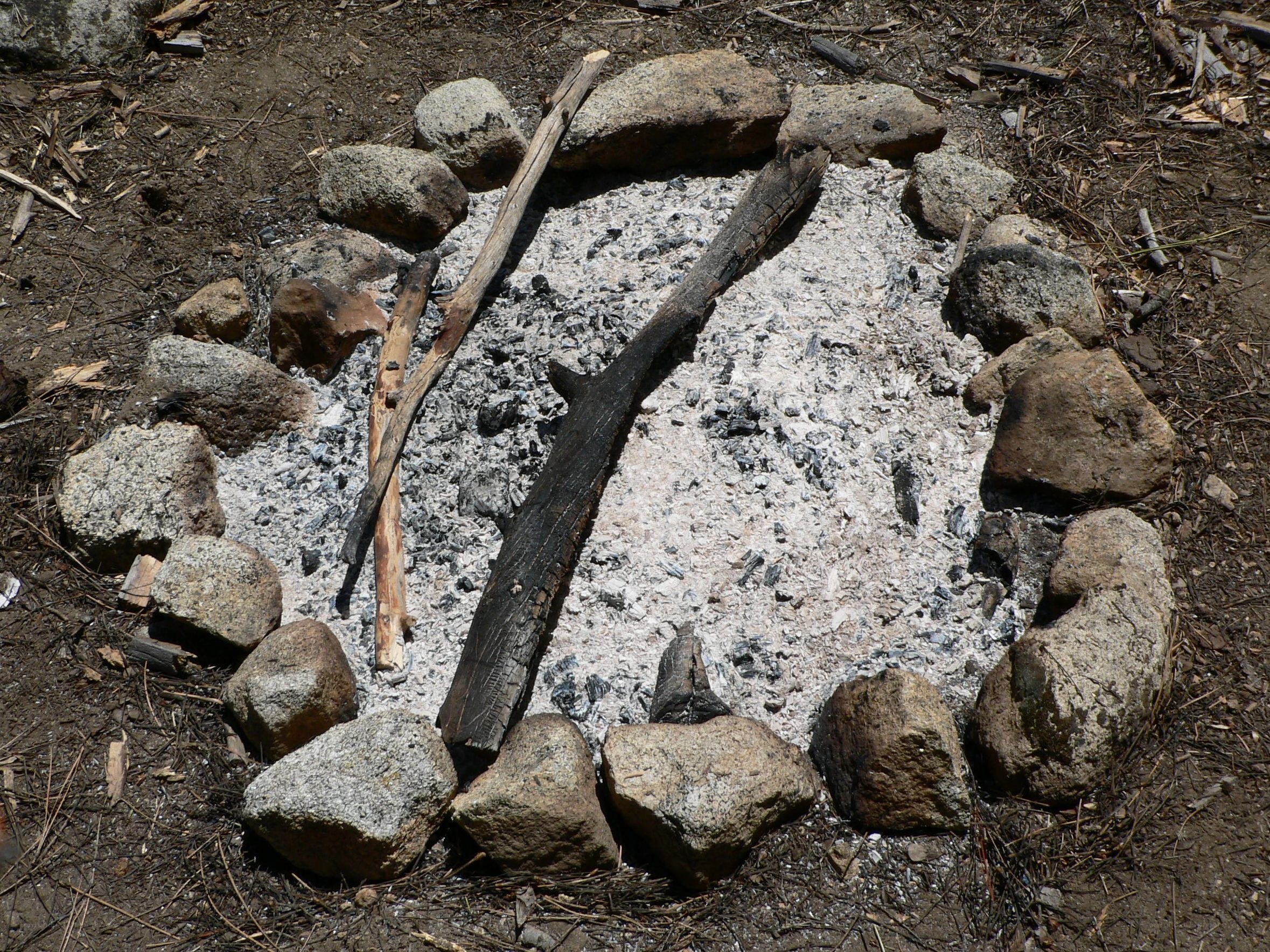 charred fire pit with rocks