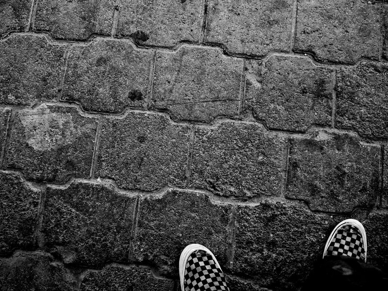 Checkered Shoes on Pavement — Black