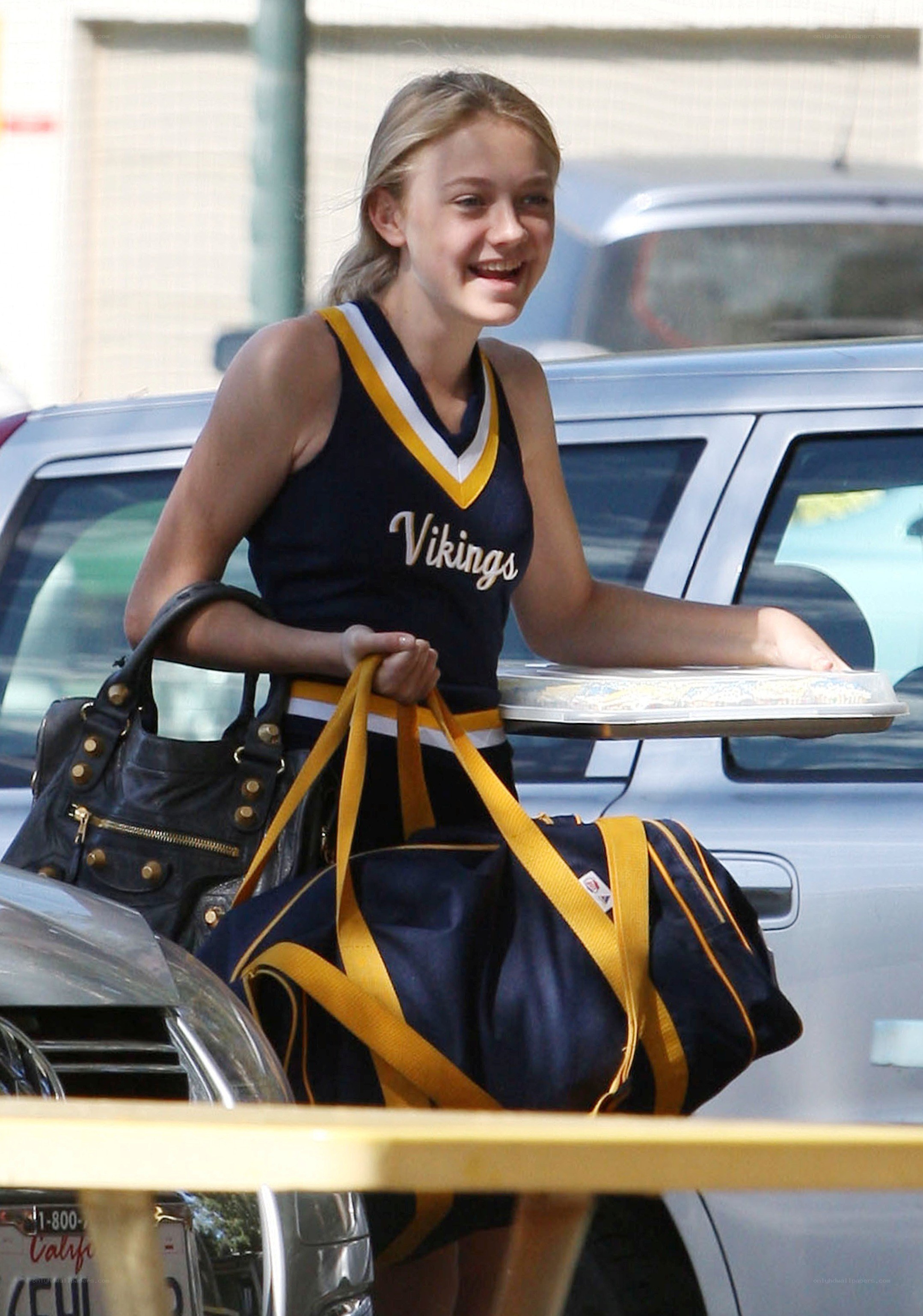 cheerleader carrying bags