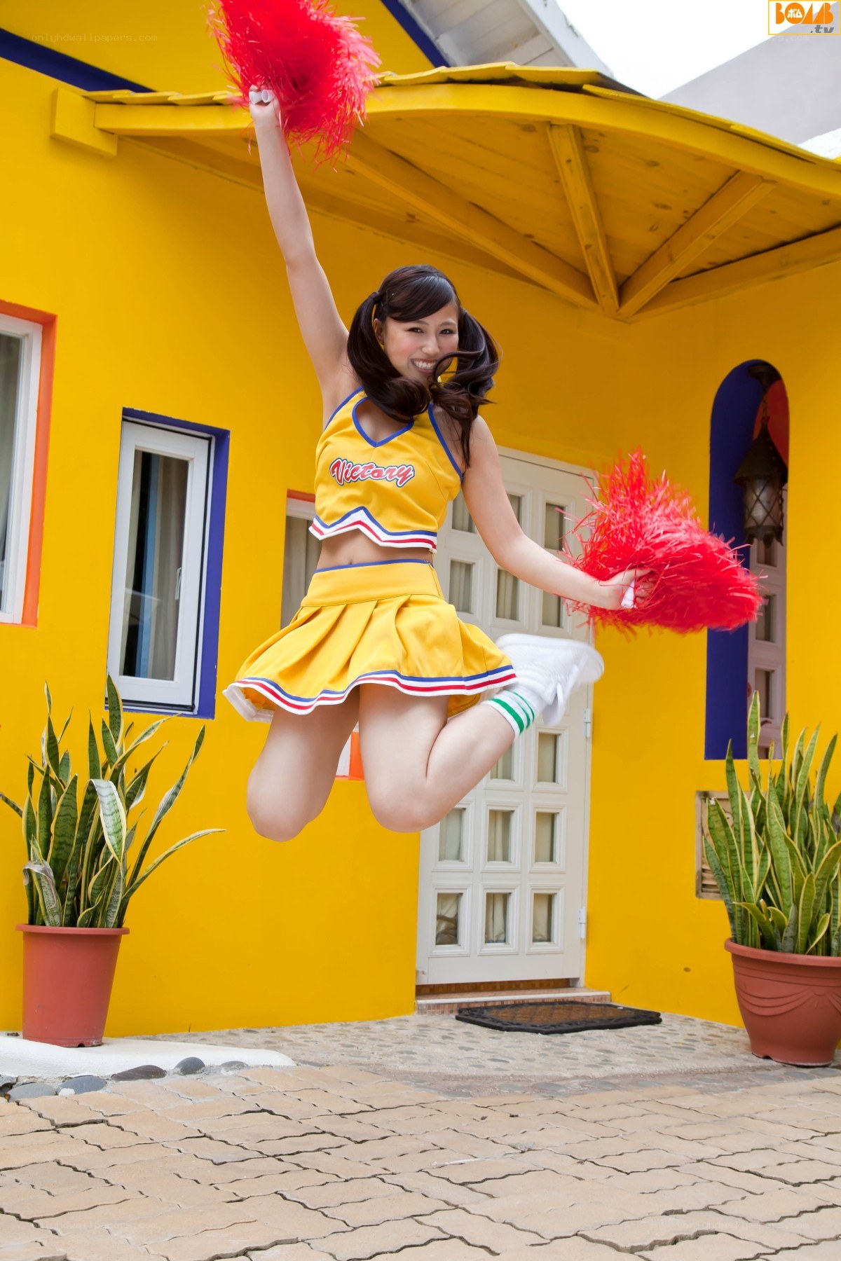 cheerleader jumping outside