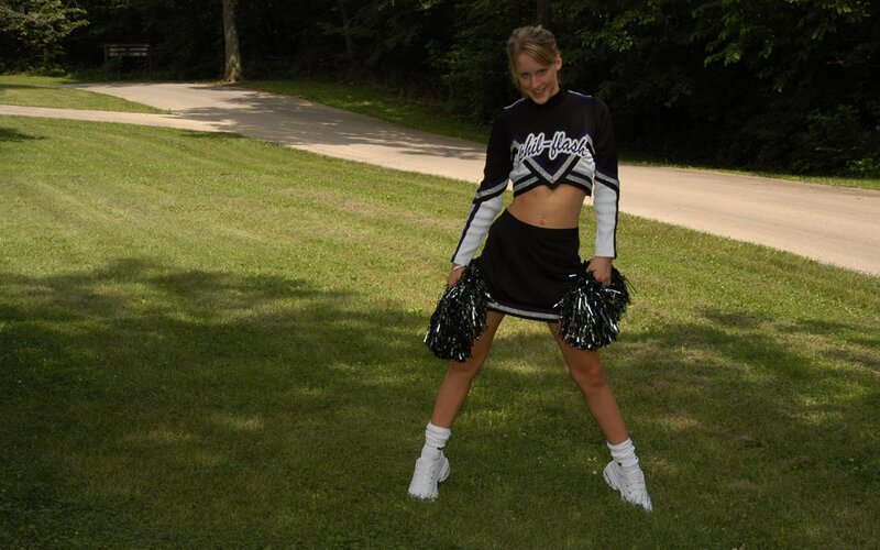 cheerleader posing outdoors