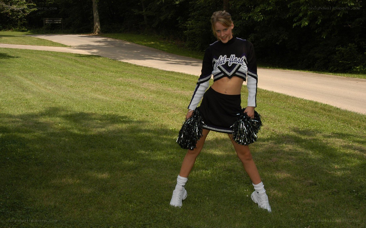 cheerleader posing outdoors