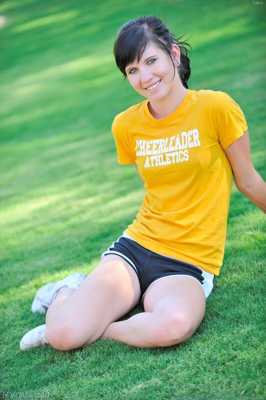 cheerleader sitting on grass