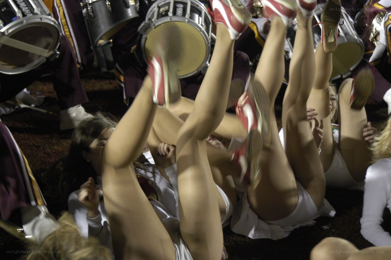 Cheerleaders celebrating on field