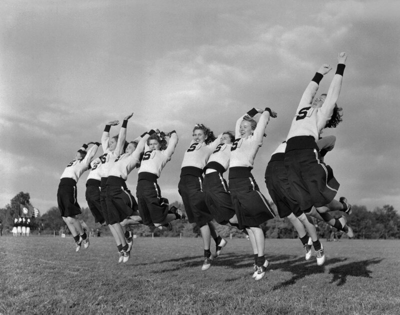 Cheerleaders jumping in unison