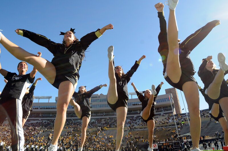 Cheerleaders performing at a football game