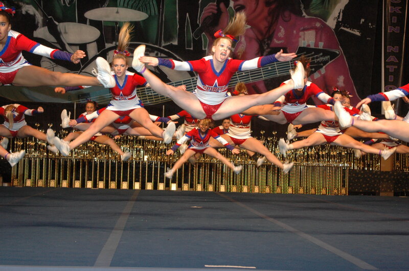 Cheerleaders Performing Stunt — Red