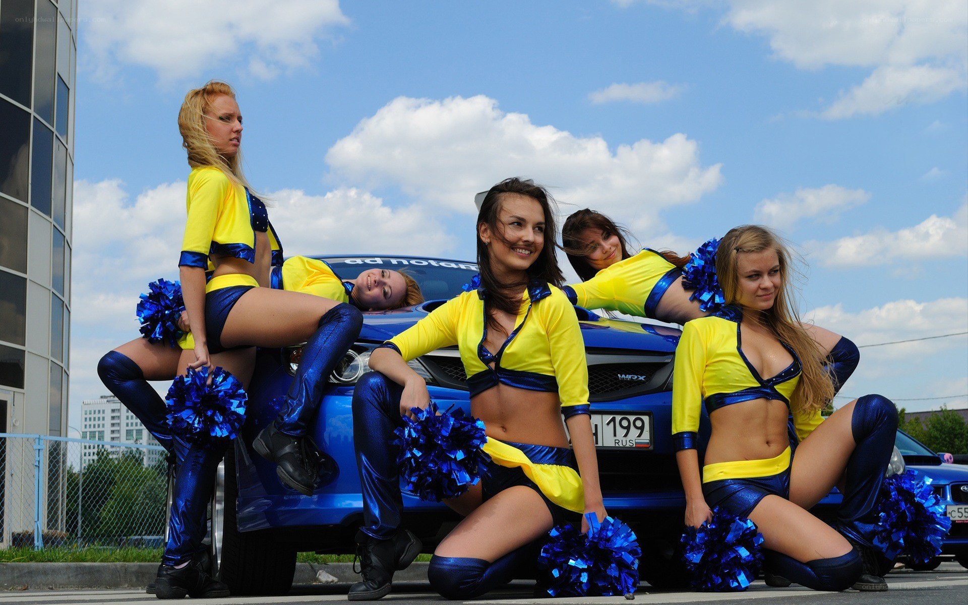 Cheerleaders with blue car