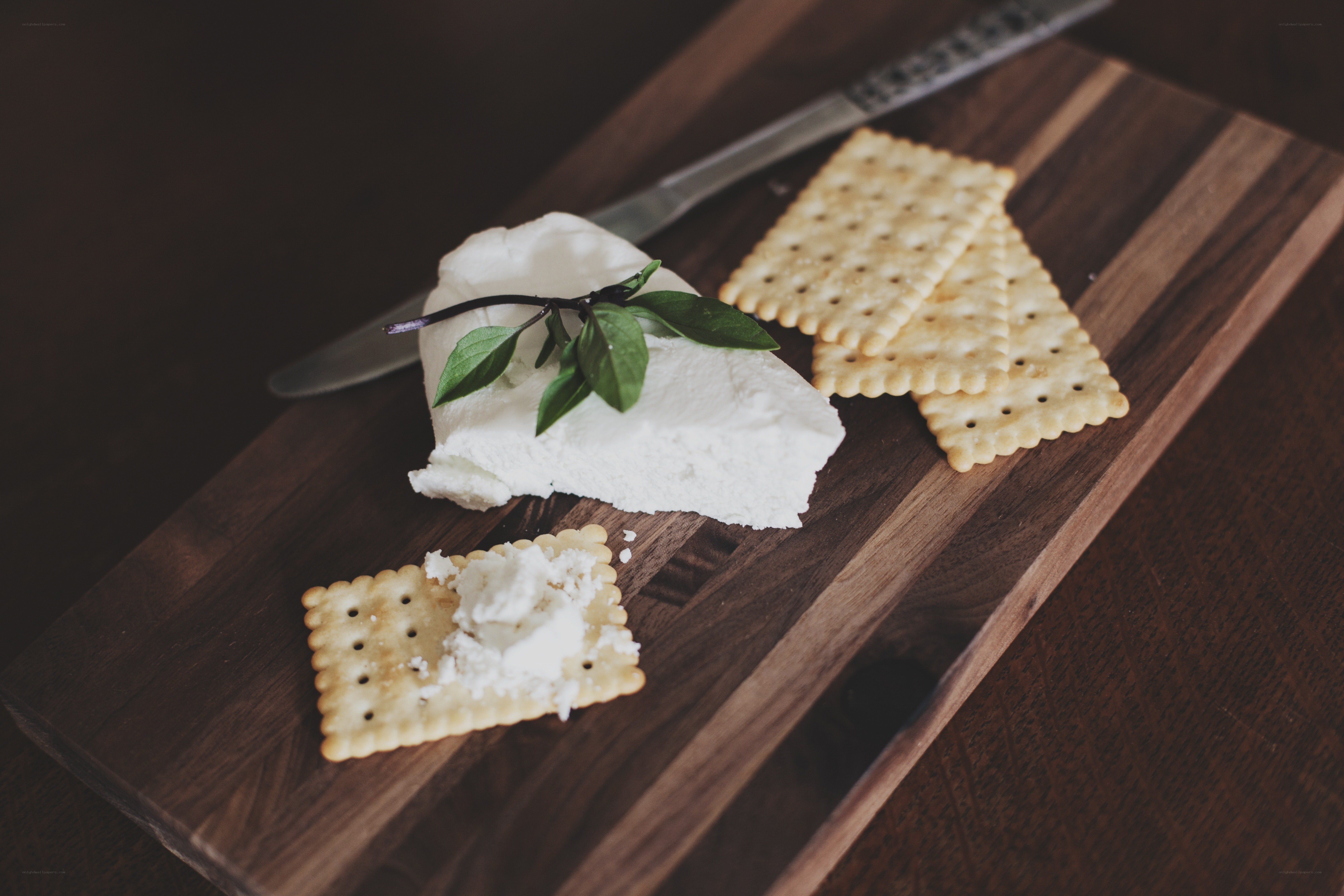 cheese and crackers on wood