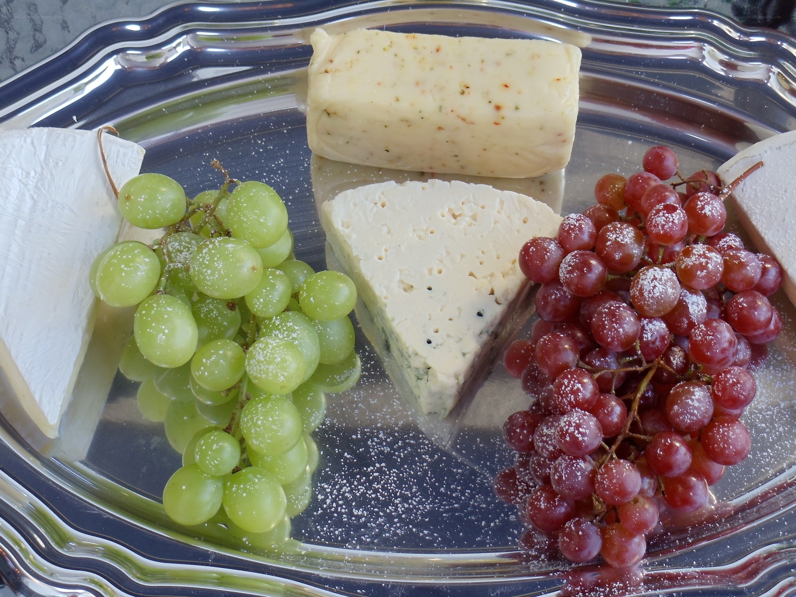 Cheese and grapes on silver tray