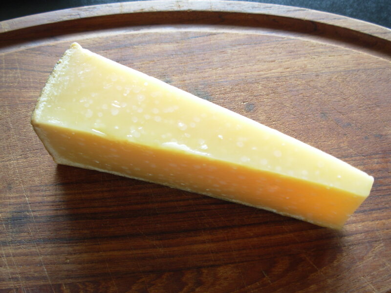 cheese wedge on wooden board