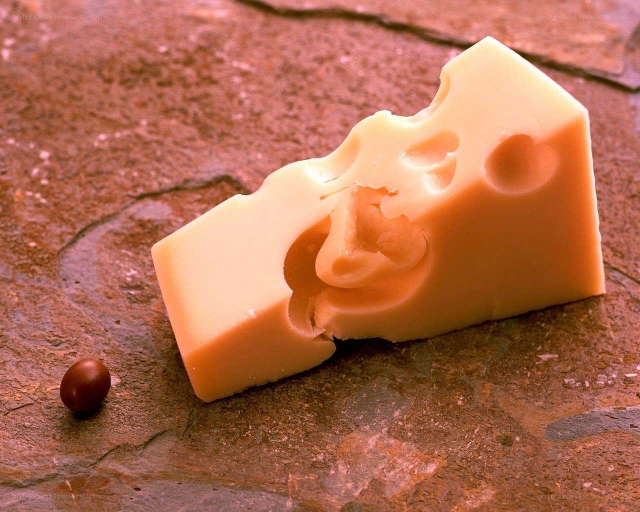 cheese with holes on stone