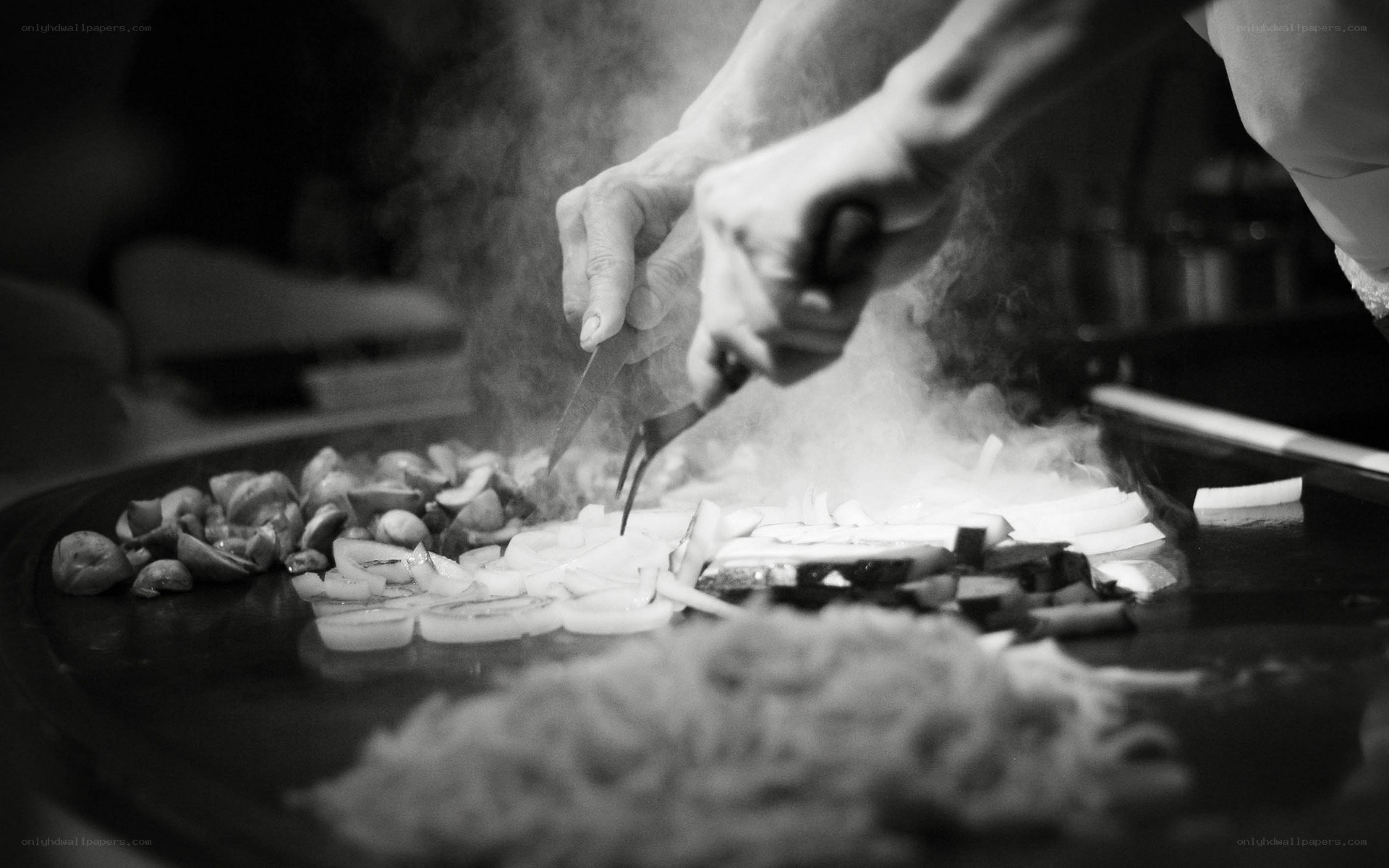 Chef cooking on a teppanyaki grill