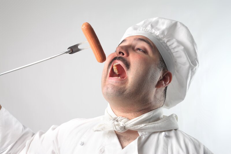 chef eating hot dog