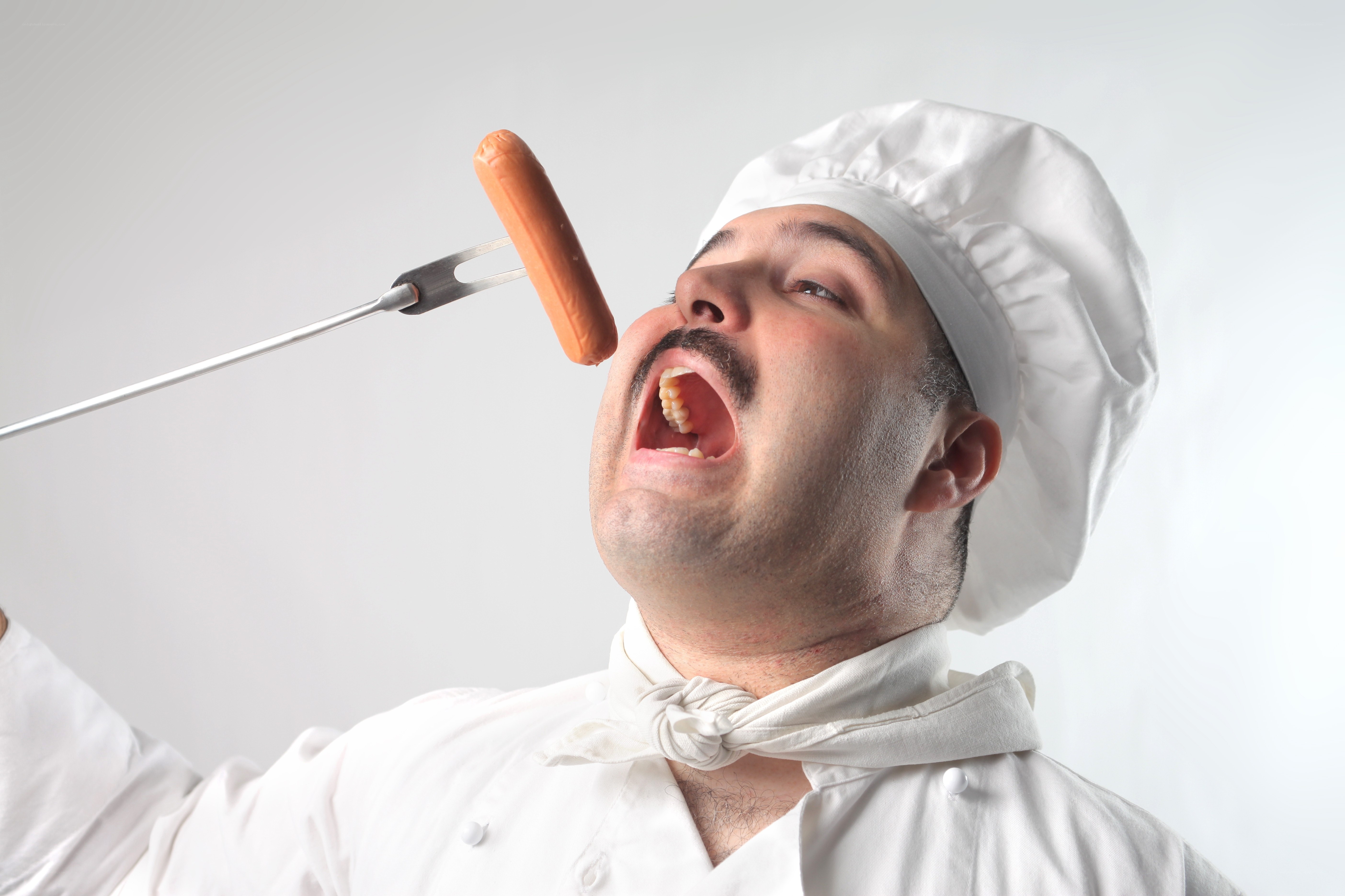 chef eating hot dog