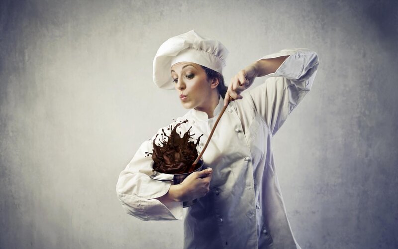 chef stirring chocolate splashing
