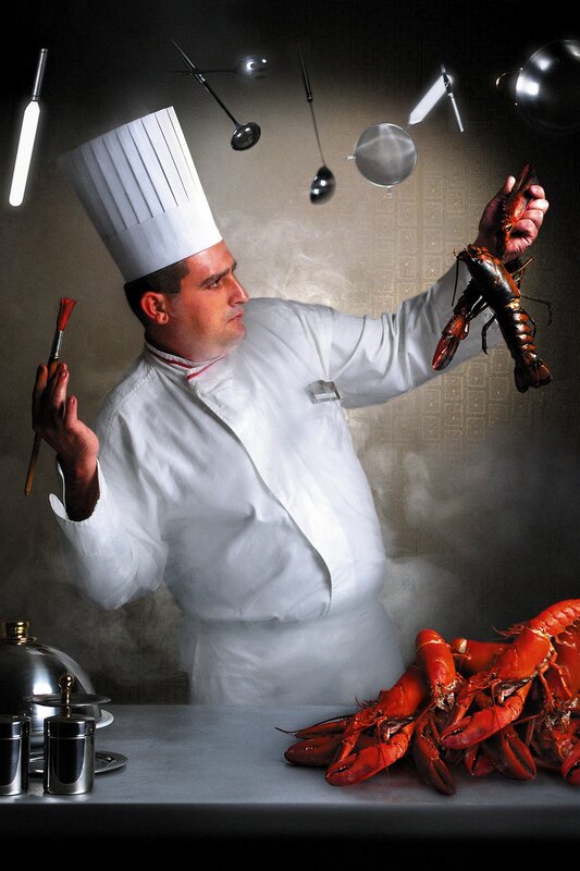 Chef with lobster and kitchen tools