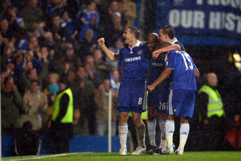 Chelsea players celebrate in rain