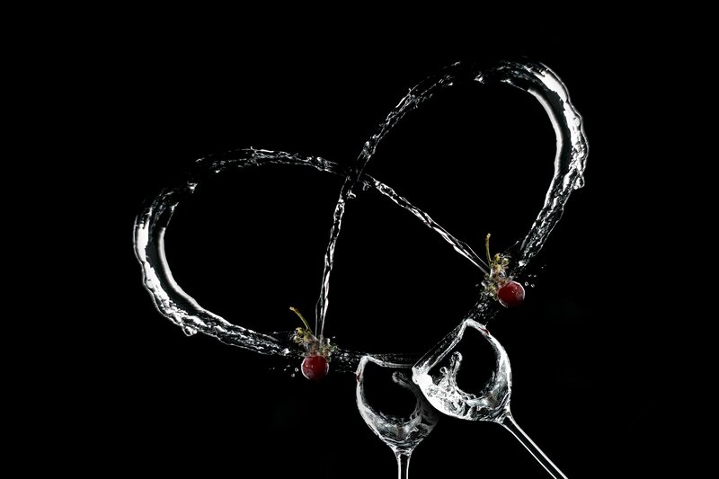 Cherries and water forming a heart