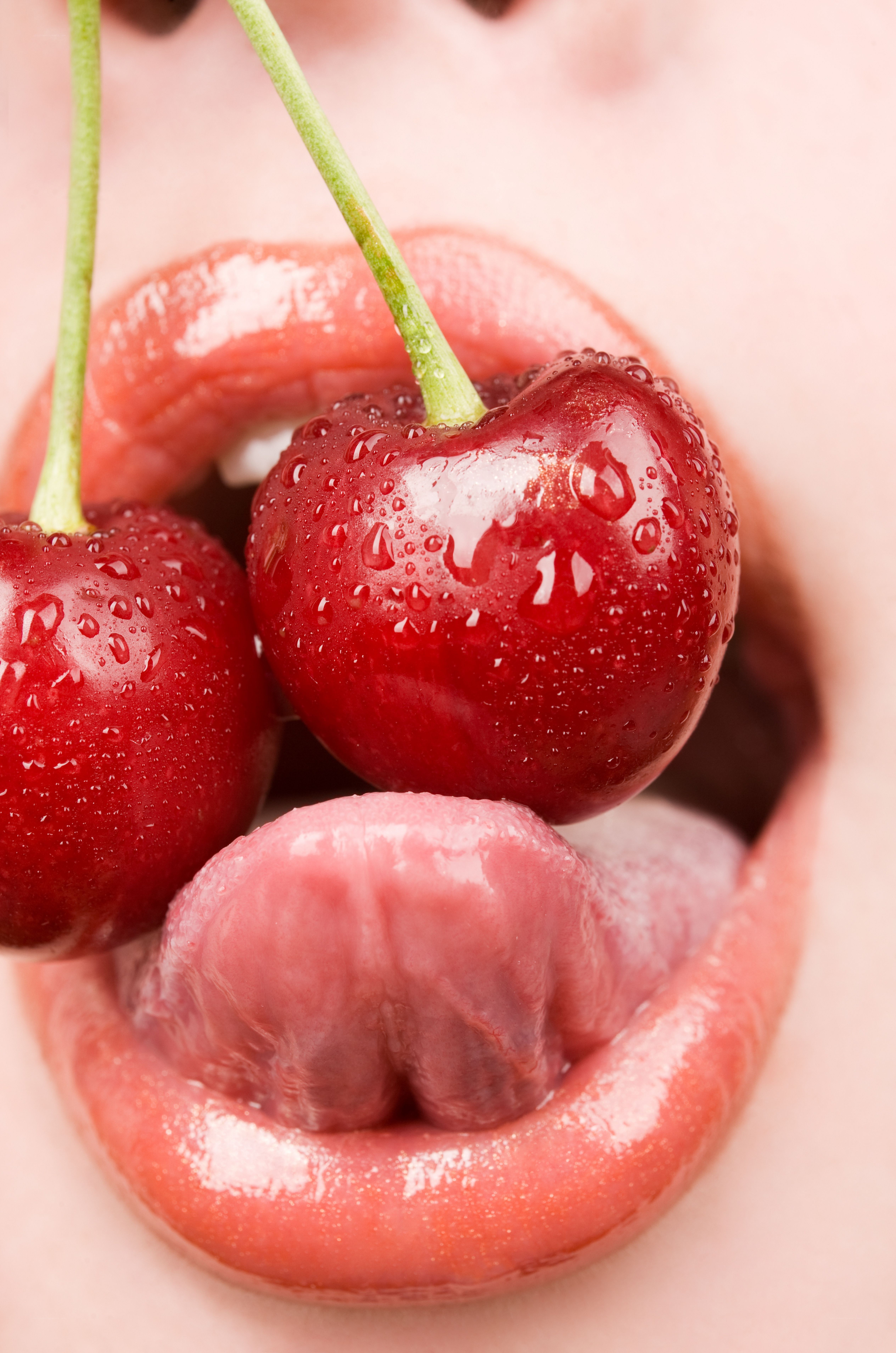 Cherries in a person's mouth