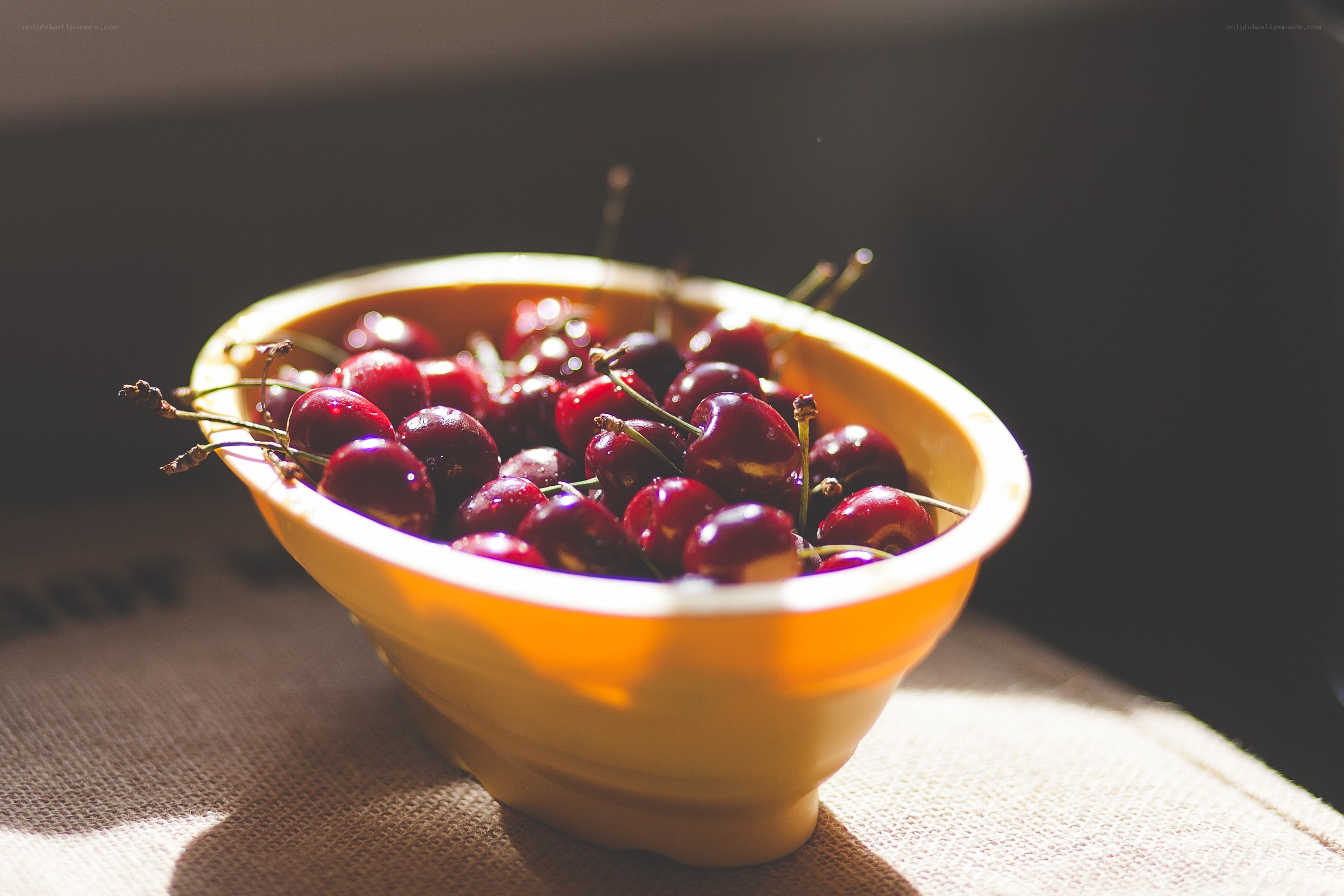 Cherries in a yellow bowl