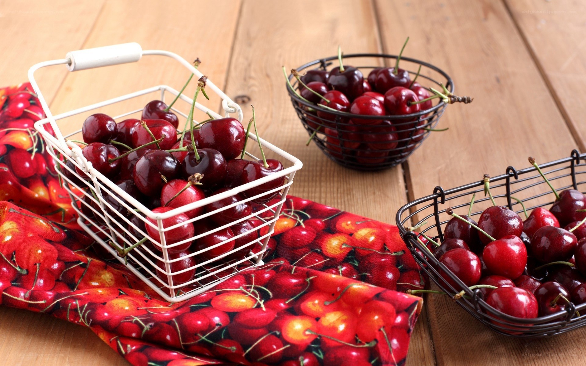 Cherries in baskets on wood