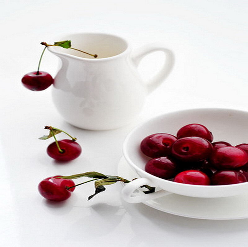 Cherries in white bowl and pitcher
