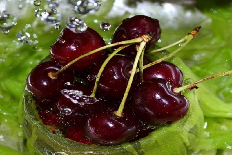 Cherries on a leaf with water