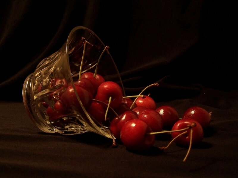 cherries spilled from glass