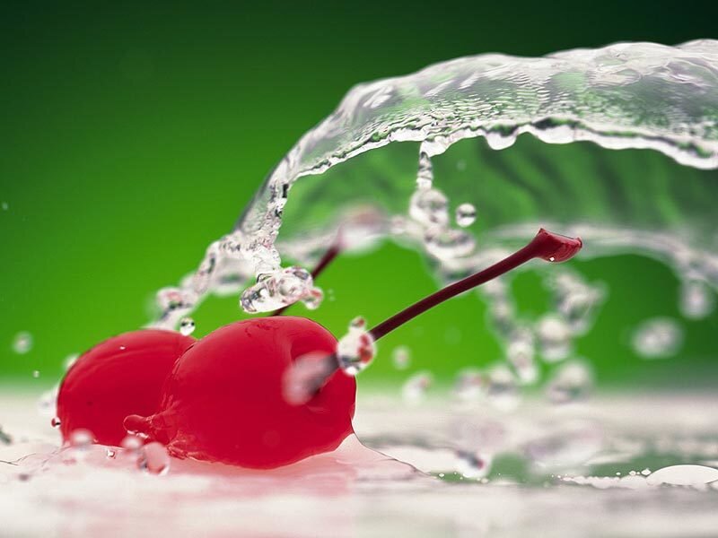 Cherries splashing in water