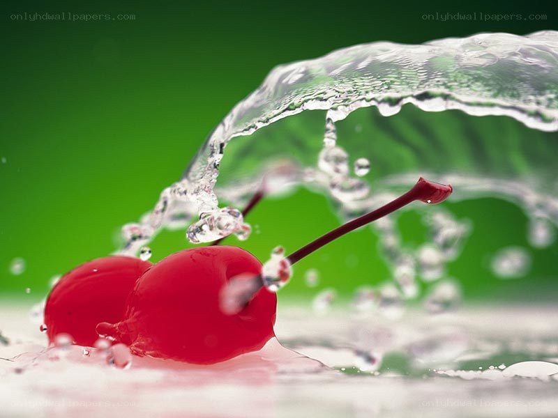 Cherries splashing in water