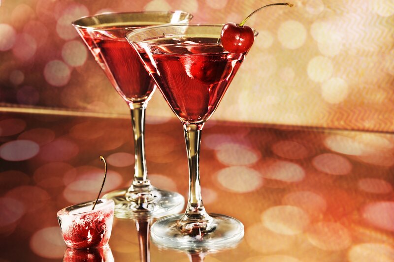 Cherry cocktails on a reflective surface