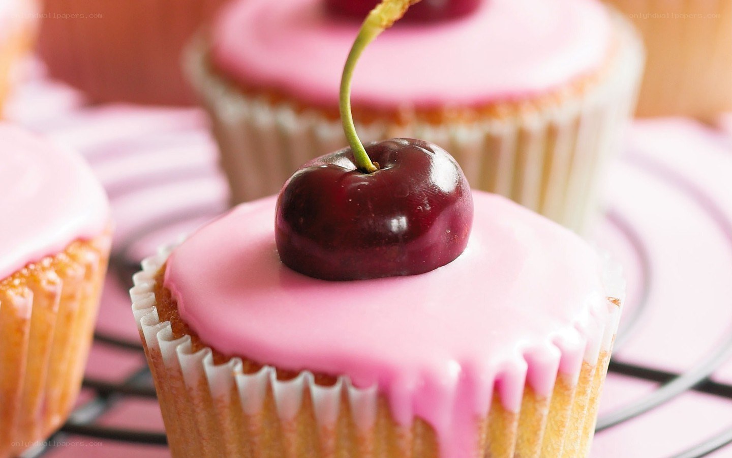 cherry cupcakes with pink icing