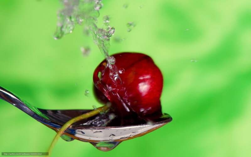 Cherry on a spoon with water splash