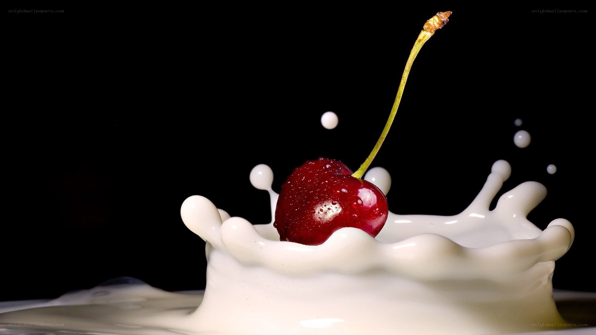 cherry splashing in milk