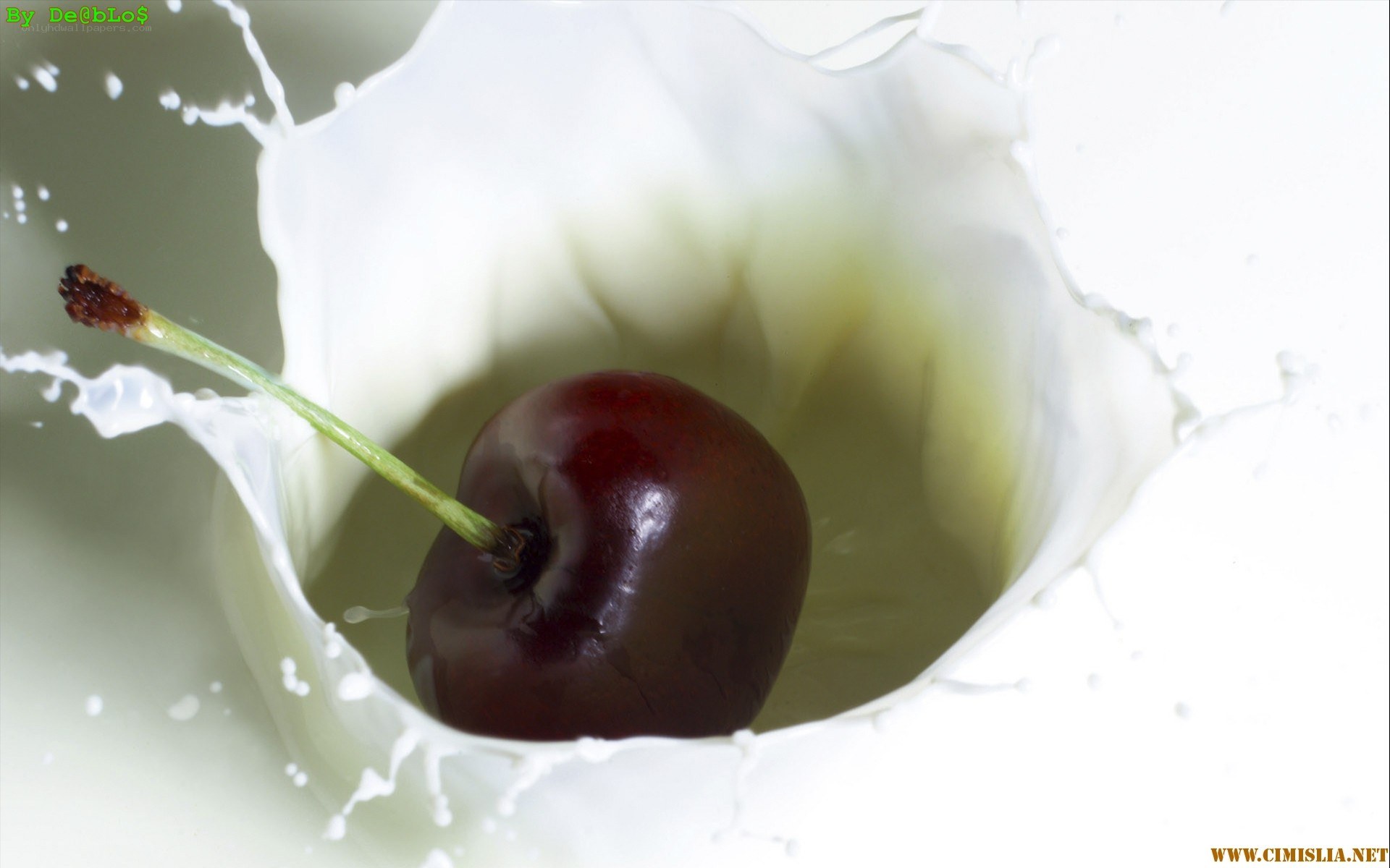 cherry splashing in milk