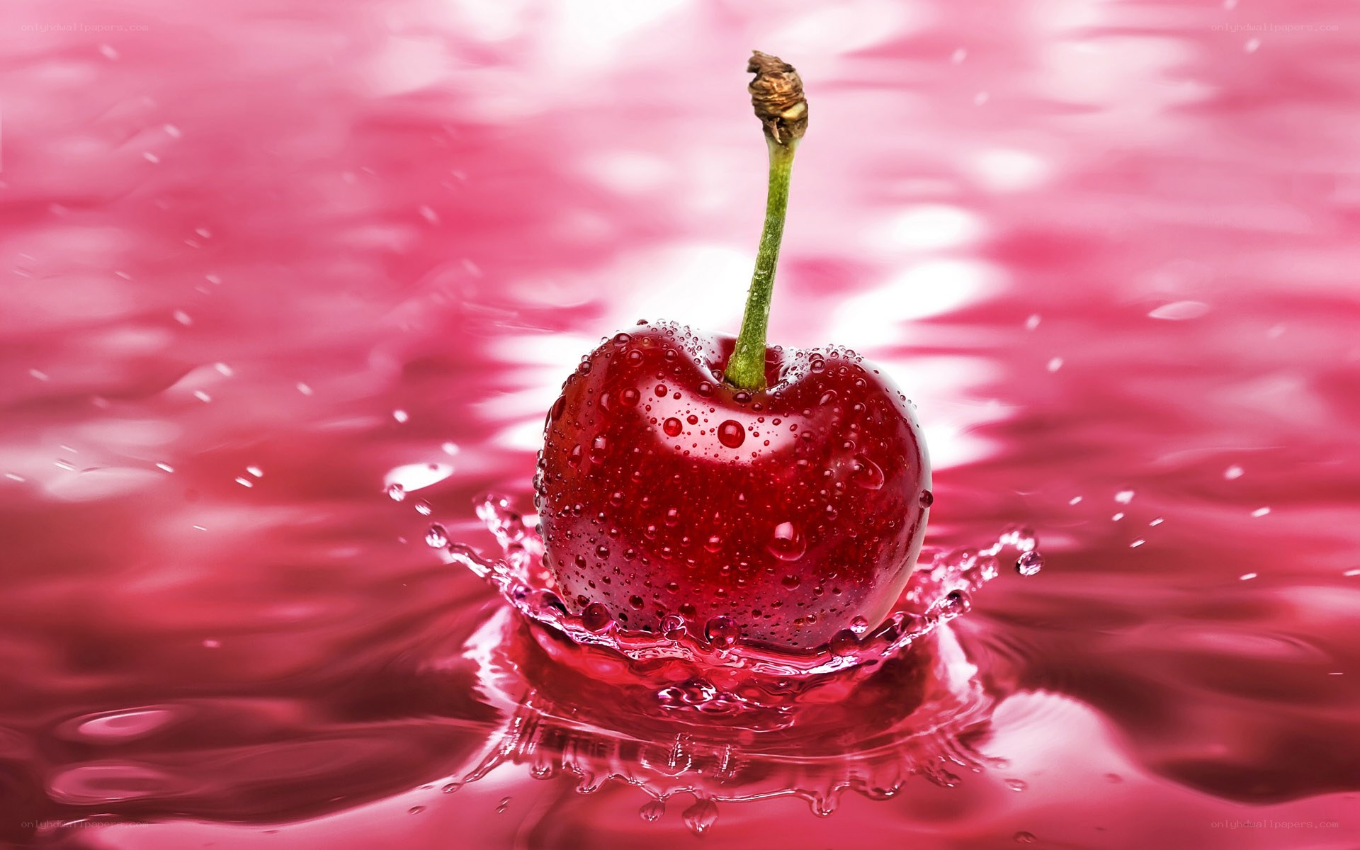 Cherry splashing in red liquid