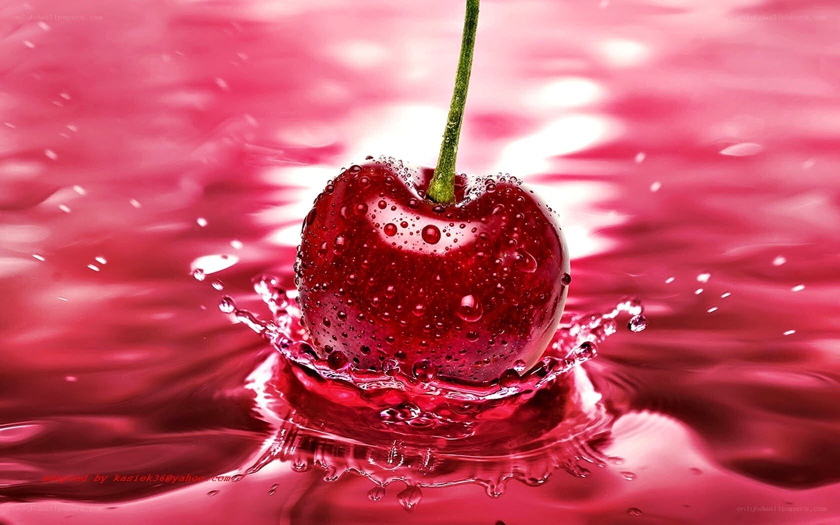Cherry splashing in red liquid